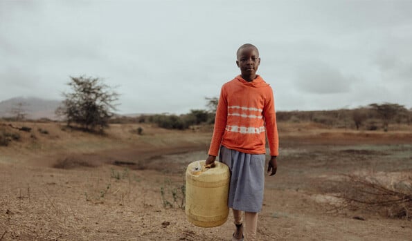 girl holding water jug
