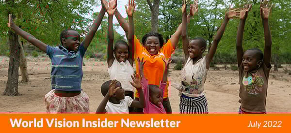 Joyful girls and staff member jumping in a World Vision program area in Zimbabwe