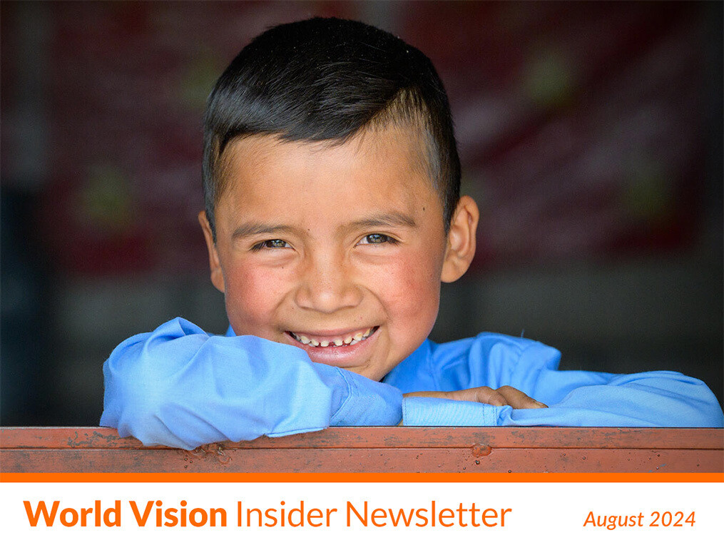 A boy smiles at the camera.