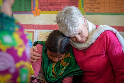 beth weibling hugging a young girl