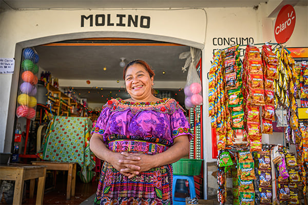 woman smiling in front of store