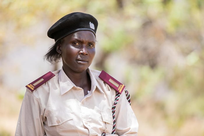 A Kenyan woman wears a uniform signifying her status as a community leader