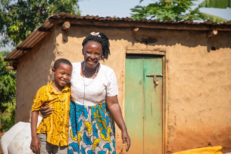 Javira and his grandmother, Dinah, outside their home in Uganda.