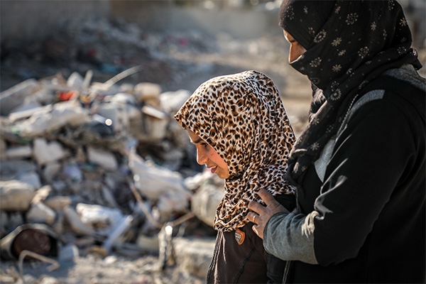 A mother and daughter seek temporary shelter amid the earthquake damage in Syria. 