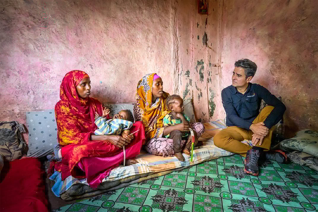 edgar sandoval sitting with two women and their babies