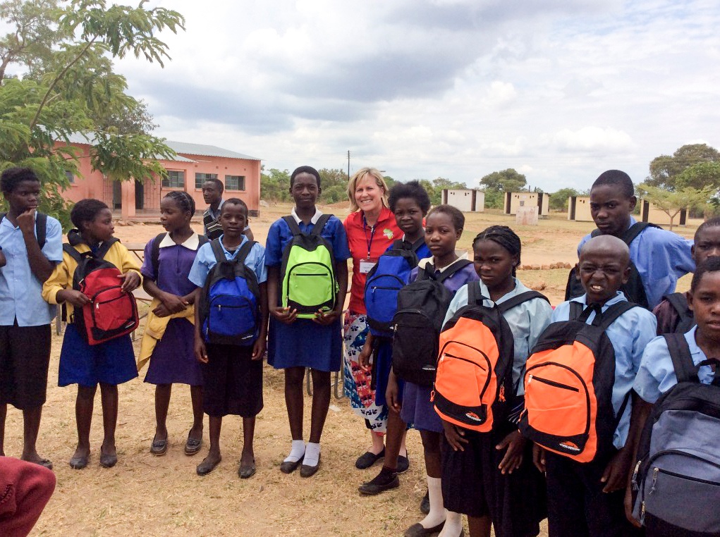 Betsy King handing out new backpacks