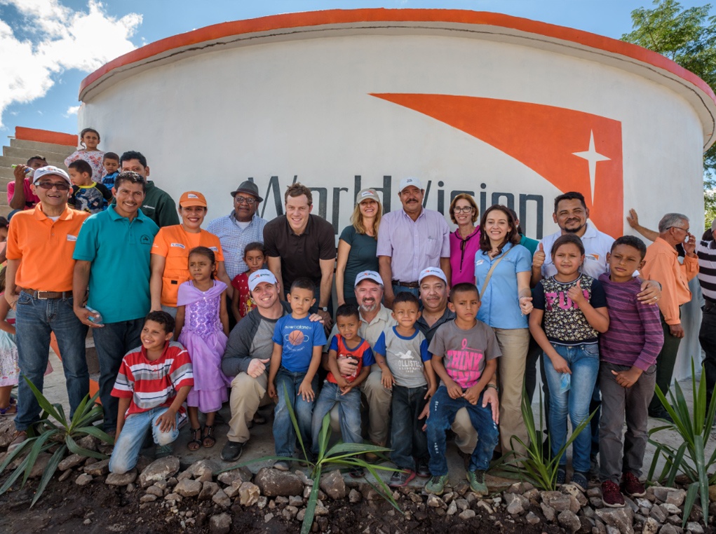 Cody Nath and other RTI employees celebrate the opening of a water system in Honduras that they funded in partnership with World Vision.