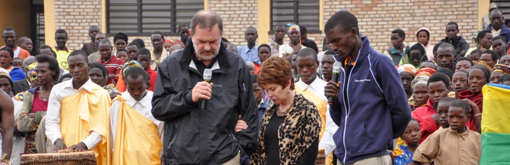The Phillips praying during the dedication of the new vocational center in Rwanda