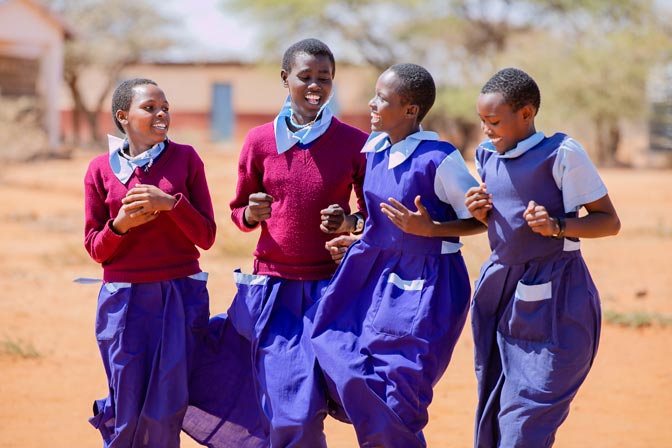 Girl students at a primary school in Samburu, Kenya, laugh together