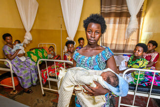 A woman holding her baby