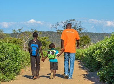 WV employee walking with children