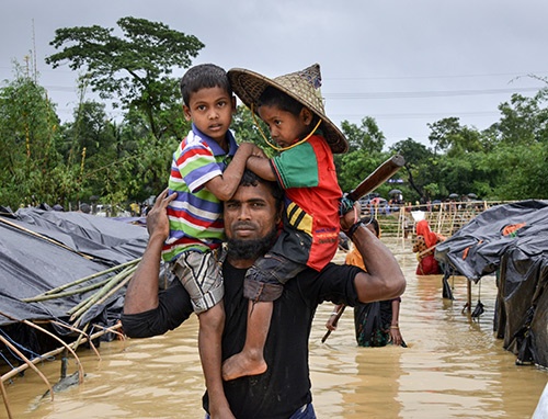 Abdul and his two sons are leaving Balukhali Refugee Camp in Bangladesh after spending a long odious night in the tent filled with rainwater.